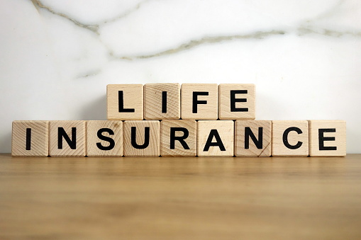 Life insurance text from wooden blocks, financial concept